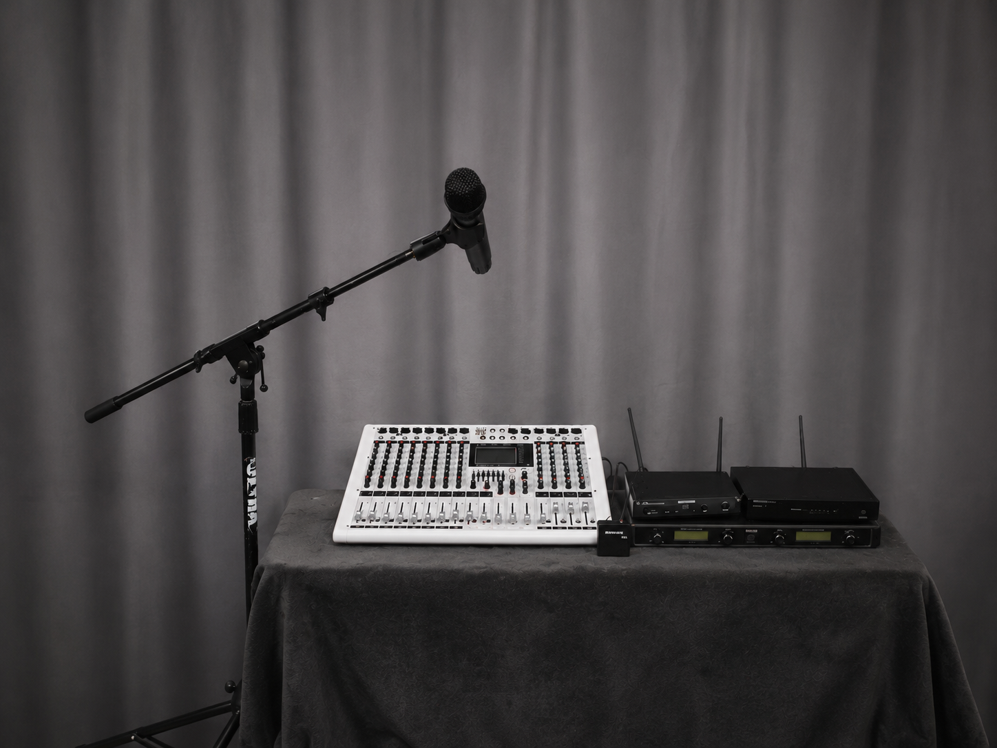 Professional audio mixer, microphone and wireless microphone receivers arranged for an event setup